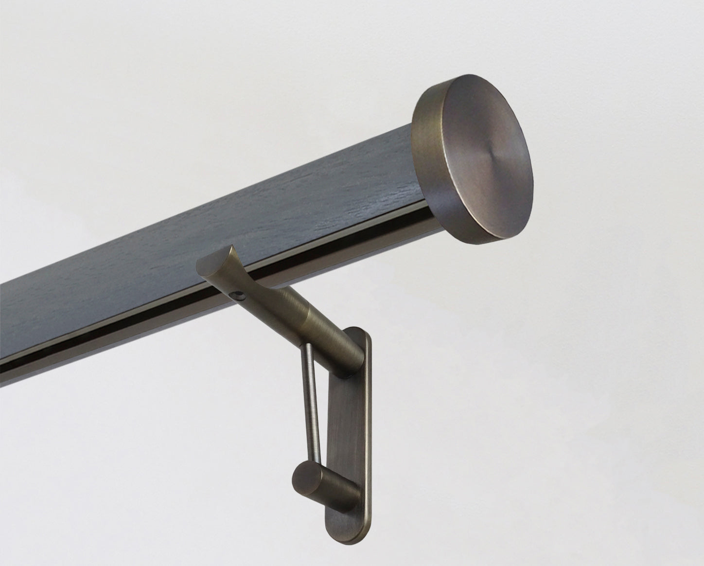 Dark grey tracked curtain pole with bronze end cap finials